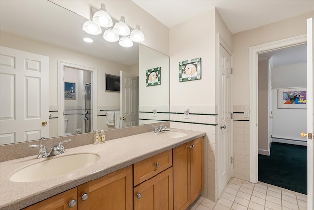 4 Hidden Valley Way, Bedford, NY 10506 - bathroom with tile patterned floors, double vanity, an enclosed shower, a baseboard heating unit, and tile walls