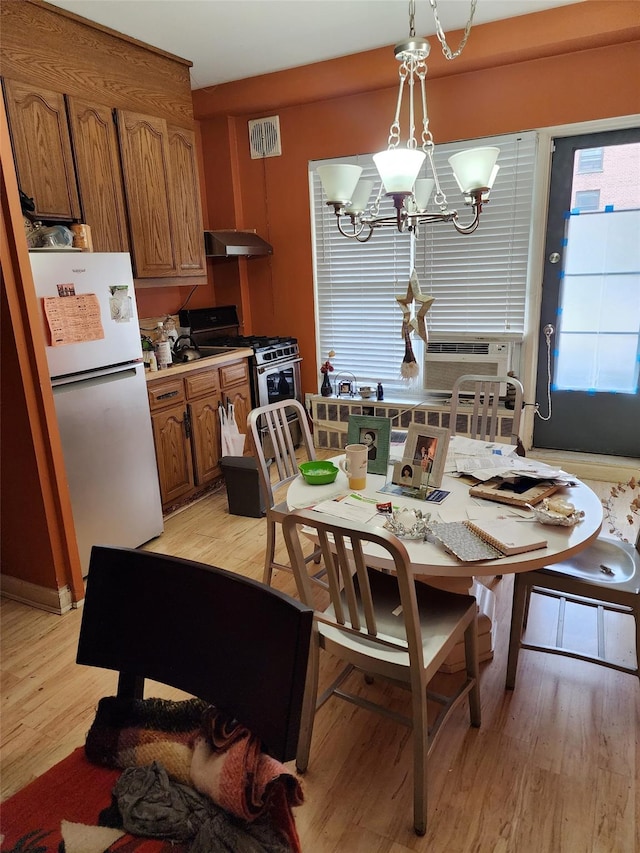 35-11 85th St Unit 1B, Jackson Heights, NY 11372 - dining area with light wood finished floors, a chandelier, and cooling unit