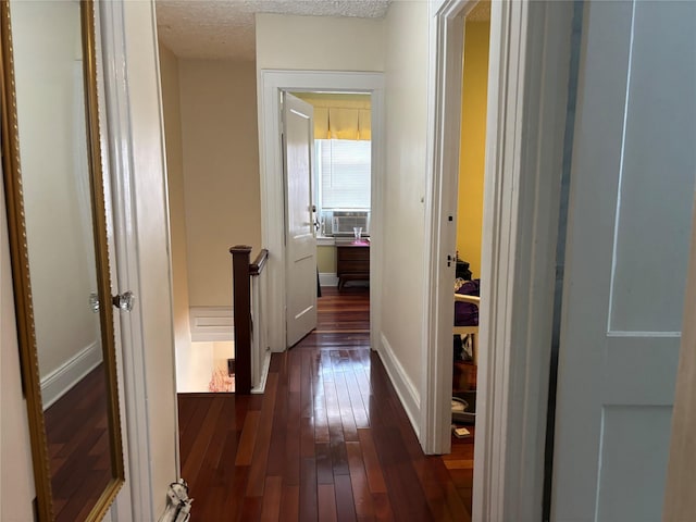 10418 216th St, Queens Village, NY 11429 - corridor with dark wood-style flooring, an upstairs landing, and a textured ceiling