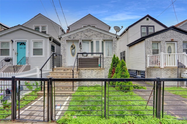 14431 166th St, Jamaica, NY 11434 - view of front of property with a gate, a fenced front yard, and entry steps