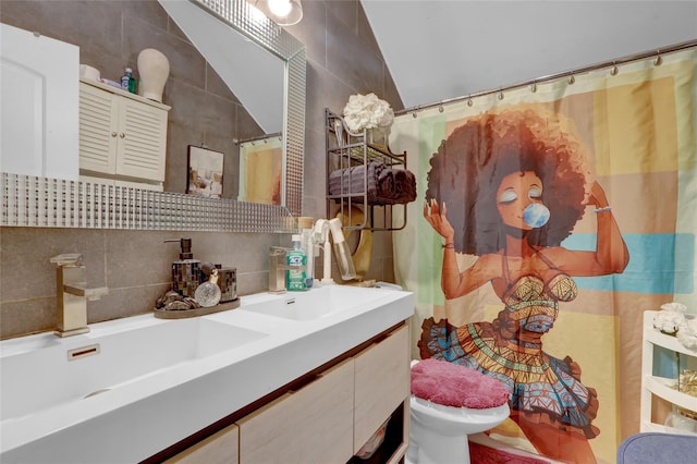 14431 166th St, Jamaica, NY 11434 - full bathroom with tile walls, vaulted ceiling, vanity, tasteful backsplash, and a shower with shower curtain