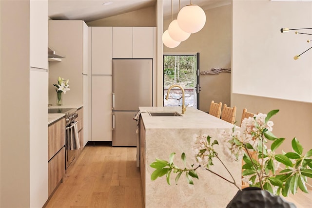 252 Swamp Pond Rd, Narrowsburg, NY 12764 - kitchen featuring modern cabinets, stainless steel appliances, wall chimney exhaust hood, light wood finished floors, and lofted ceiling