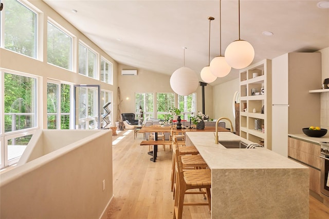 252 Swamp Pond Rd, Narrowsburg, NY 12764 - kitchen featuring modern cabinets, pendant lighting, light wood finished floors, an island with sink, and high vaulted ceiling