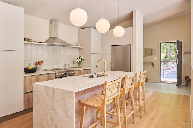 252 Swamp Pond Rd, Narrowsburg, NY 12764 - kitchen featuring wall chimney range hood, modern cabinets, appliances with stainless steel finishes, tasteful backsplash, and lofted ceiling