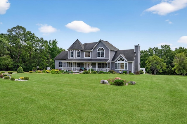 40 Rapelje Rd, Walden, NY 12586 - view of front of property with covered porch, a chimney, and a front lawn