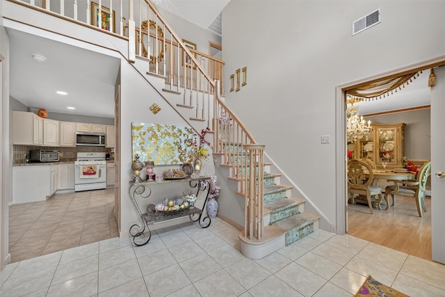 40 Rapelje Rd, Walden, NY 12586 - staircase with a high ceiling, tile patterned flooring, a chandelier, and recessed lighting