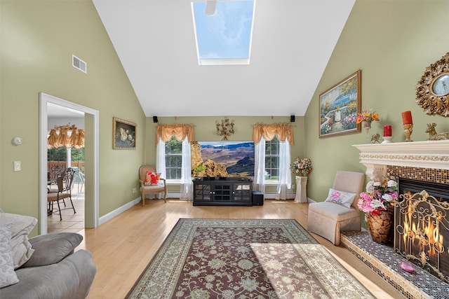 40 Rapelje Rd, Walden, NY 12586 - living room with high vaulted ceiling, wood finished floors, a skylight, and a fireplace