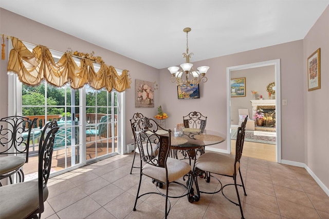 40 Rapelje Rd, Walden, NY 12586 - dining space with light tile patterned flooring, a chandelier, and a lit fireplace