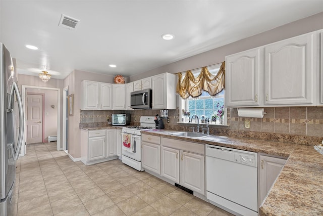 40 Rapelje Rd, Walden, NY 12586 - kitchen with appliances with stainless steel finishes, white cabinetry, decorative backsplash, a baseboard radiator, and recessed lighting
