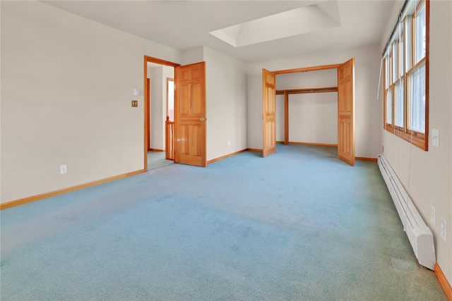 33 Park Cir, New Hyde Park, NY 11040 - unfurnished bedroom featuring baseboard heating, light carpet, a raised ceiling, and a closet