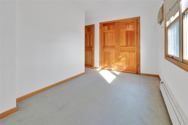 33 Park Cir, New Hyde Park, NY 11040 - carpeted empty room featuring a baseboard heating unit and a wall unit AC