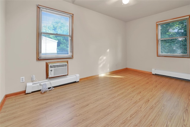 33 Park Cir, New Hyde Park, NY 11040 - unfurnished room featuring a baseboard heating unit, a wall unit AC, wood finished floors, and a baseboard radiator