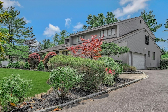160 Coachman Pl E, Syosset, NY 11791 - view of front of house featuring an attached garage, asphalt driveway, and a front yard