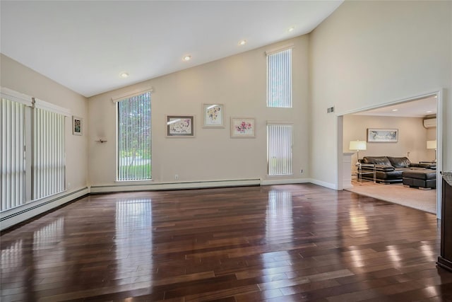 160 Coachman Pl E, Syosset, NY 11791 - unfurnished living room with plenty of natural light, wood-type flooring, a wall mounted AC, a towering ceiling, and recessed lighting