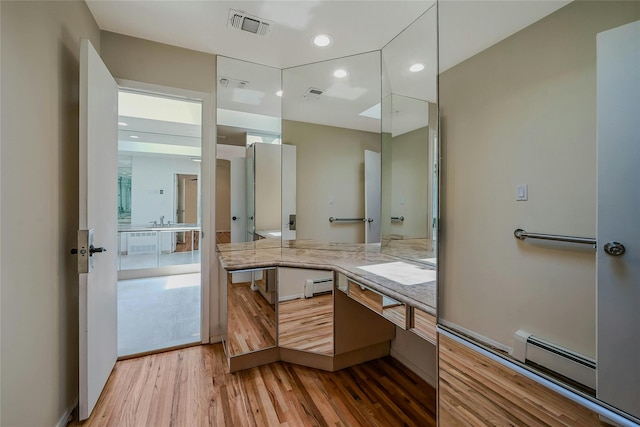 160 Coachman Pl E, Syosset, NY 11791 - full bathroom with wood finished floors, vanity, recessed lighting, and a baseboard radiator