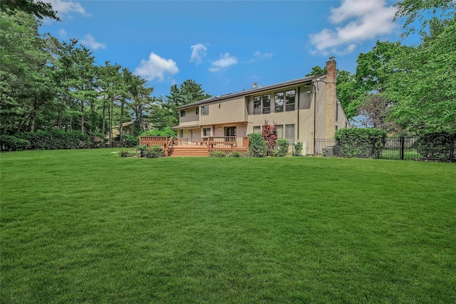 160 Coachman Pl E, Syosset, NY 11791 - back of house with a chimney and a wooden deck