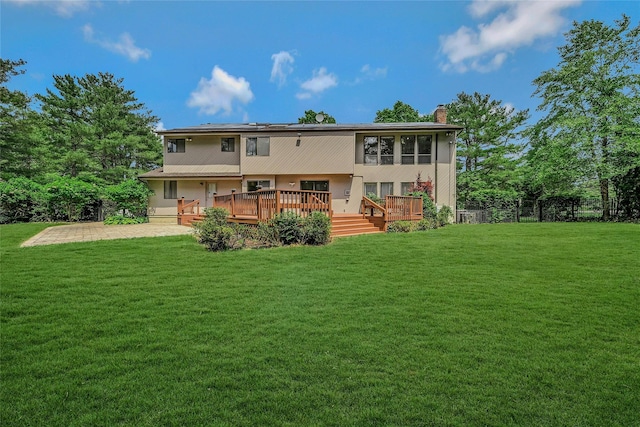 160 Coachman Pl E, Syosset, NY 11791 - rear view of house with a chimney, a lawn, and a wooden deck
