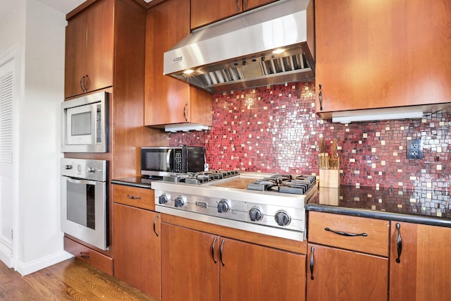 2 Harbor Ln Unit 301, New Rochelle, NY 10805 - kitchen featuring appliances with stainless steel finishes, exhaust hood, wood finished floors, and brown cabinetry