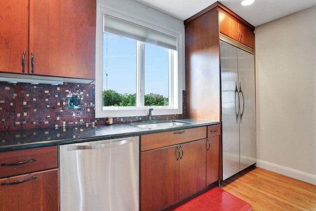 2 Harbor Ln Unit 301, New Rochelle, NY 10805 - kitchen featuring stainless steel appliances, dark countertops, tasteful backsplash, and light wood finished floors