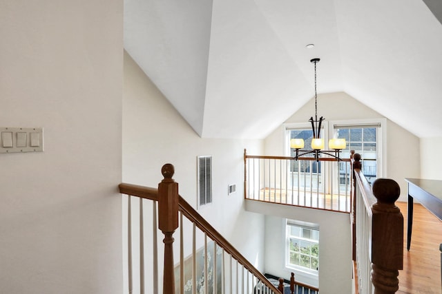 2 Harbor Ln Unit 301, New Rochelle, NY 10805 - stairway featuring a chandelier, lofted ceiling, and wood finished floors