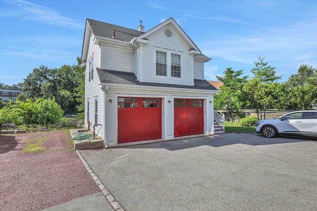2 Harbor Ln Unit 301, New Rochelle, NY 10805 - view of front of house with a shingled roof, a garage, and asphalt driveway