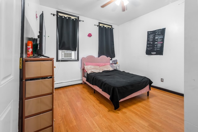 2370 Atlantic Ave, Brooklyn, NY 11233 - bedroom with cooling unit, a baseboard heating unit, light wood-type flooring, and ceiling fan