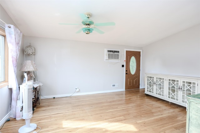 10 Jan Ct, Ronkonkoma, NY 11779 - foyer entrance featuring ceiling fan, an AC wall unit, and light wood-style floors