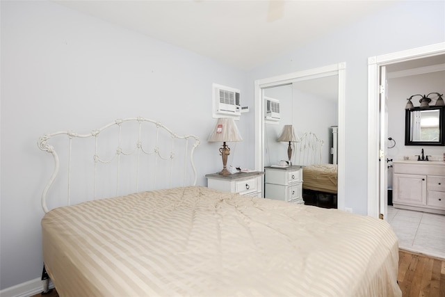 10 Jan Ct, Ronkonkoma, NY 11779 - bedroom featuring light wood finished floors, vaulted ceiling, a closet, ensuite bath, and ceiling fan