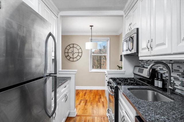 2 Bronxville Rd Unit 4L, Bronxville, NY 10708 - kitchen with stainless steel appliances, white cabinetry, tasteful backsplash, ornamental molding, and light wood-style floors