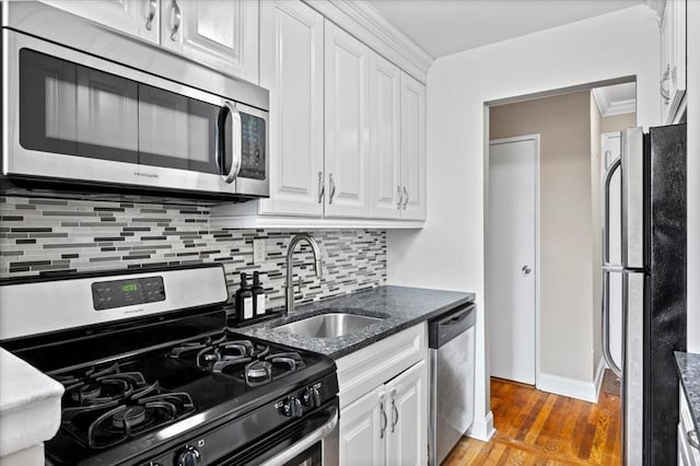 2 Bronxville Rd Unit 4L, Bronxville, NY 10708 - kitchen with appliances with stainless steel finishes, white cabinetry, decorative backsplash, light wood finished floors, and dark stone counters