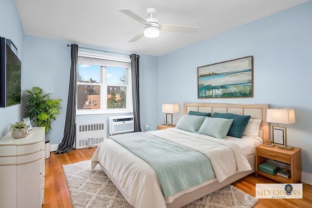 2 Bronxville Rd Unit 4L, Bronxville, NY 10708 - bedroom featuring radiator, light wood finished floors, a wall mounted air conditioner, and ceiling fan