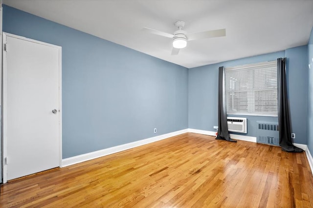 2 Bronxville Rd Unit 4L, Bronxville, NY 10708 - empty room featuring radiator, wood finished floors, an AC wall unit, and a ceiling fan