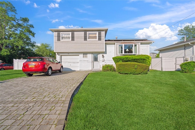 343 W 16th St, Deer Park, NY 11729 - tri-level home featuring decorative driveway, brick siding, and a garage