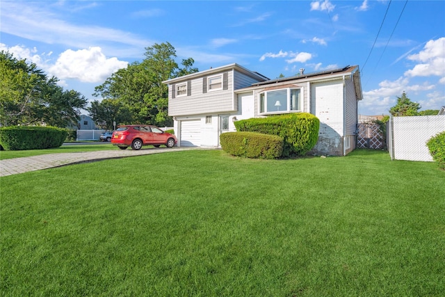343 W 16th St, Deer Park, NY 11729 - split level home featuring driveway, roof mounted solar panels, and an attached garage