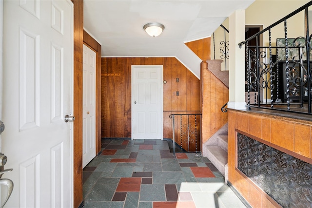 343 W 16th St, Deer Park, NY 11729 - foyer featuring stone tile floors, stairs, and wood walls