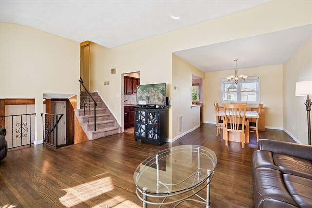 343 W 16th St, Deer Park, NY 11729 - living room featuring a chandelier, dark wood-type flooring, and stairs