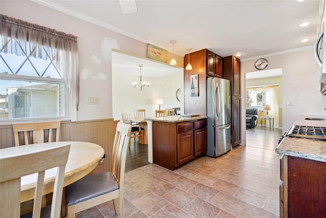 343 W 16th St, Deer Park, NY 11729 - kitchen with freestanding refrigerator, ornamental molding, a chandelier, light stone countertops, and decorative light fixtures