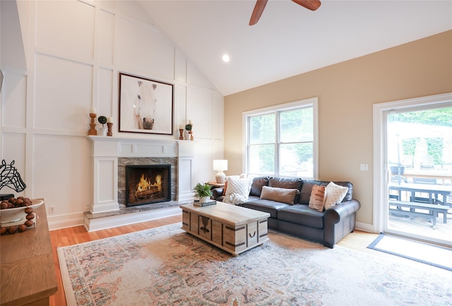 212 Weber Hill Rd, Carmel, NY 10512 - living room featuring plenty of natural light, ceiling fan, light wood-type flooring, vaulted ceiling, and a premium fireplace