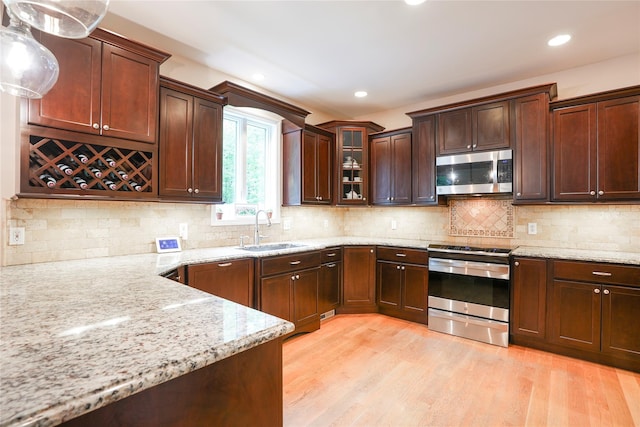 212 Weber Hill Rd, Carmel, NY 10512 - kitchen with stainless steel appliances, light stone countertops, light wood finished floors, glass insert cabinets, and recessed lighting
