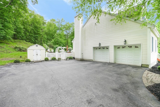 212 Weber Hill Rd, Carmel, NY 10512 - view of side of property with a storage shed, driveway, and a chimney
