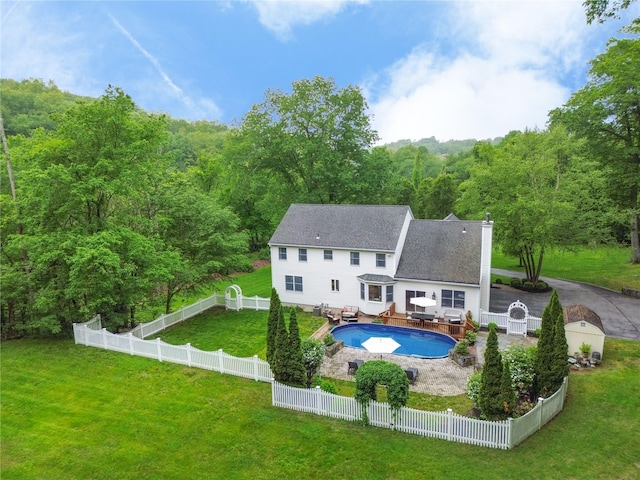 212 Weber Hill Rd, Carmel, NY 10512 - rear view of house with a wooded view, a fenced backyard, a wooden deck, and outdoor dining area