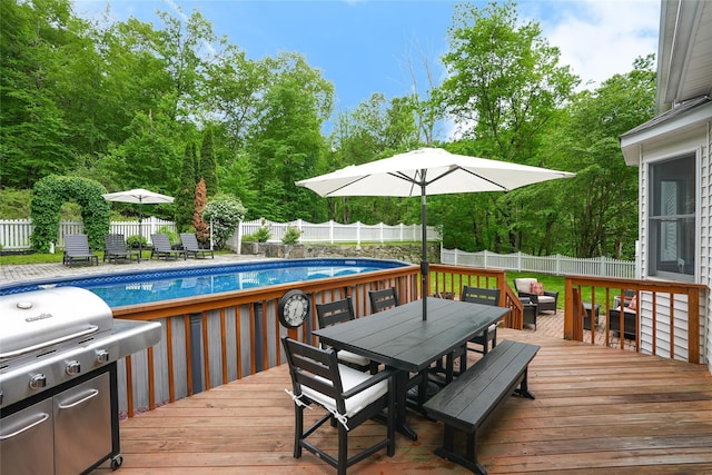 212 Weber Hill Rd, Carmel, NY 10512 - wooden deck with outdoor dining space, a fenced backyard, area for grilling, and view of wooded area