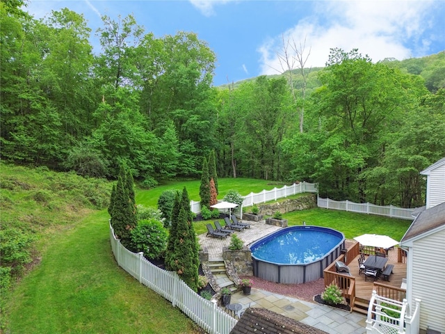 212 Weber Hill Rd, Carmel, NY 10512 - view of swimming pool featuring a deck, a fenced backyard, and a forest view