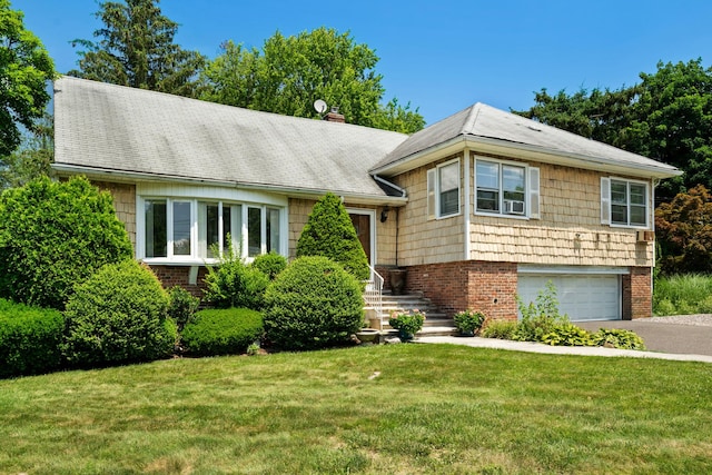 63 Bonnie Meadow Rd, Scarsdale, NY 10583 - split level home featuring asphalt driveway, a front yard, an attached garage, a chimney, and roof with shingles