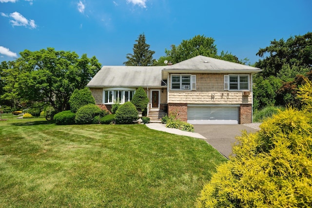 63 Bonnie Meadow Rd, Scarsdale, NY 10583 - split level home featuring asphalt driveway, an attached garage, a front yard, and brick siding