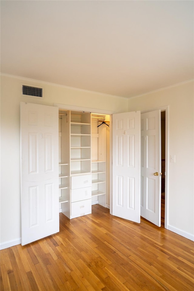 81 Seaview Ave, New Rochelle, NY 10801 - unfurnished bedroom with wood finished floors, crown molding, and a closet
