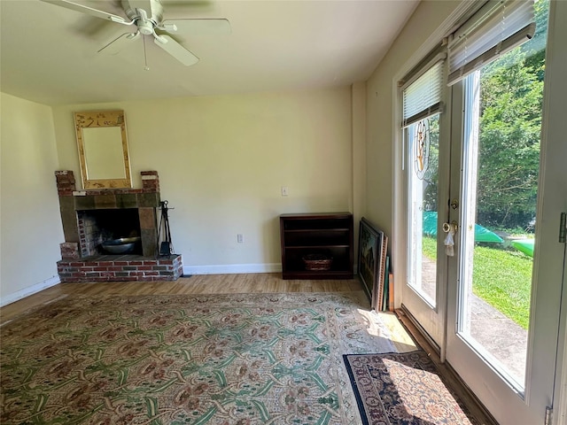 81 Seaview Ave, New Rochelle, NY 10801 - unfurnished living room with a brick fireplace, wood finished floors, and ceiling fan