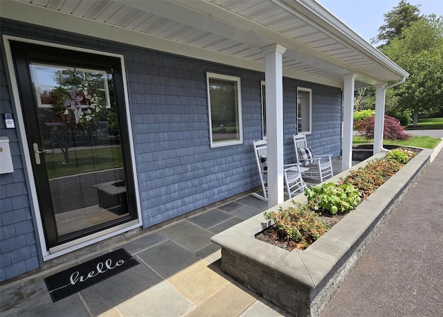 68 Palmer Dr, Sayville, NY 11782 - view of exterior entry featuring a porch