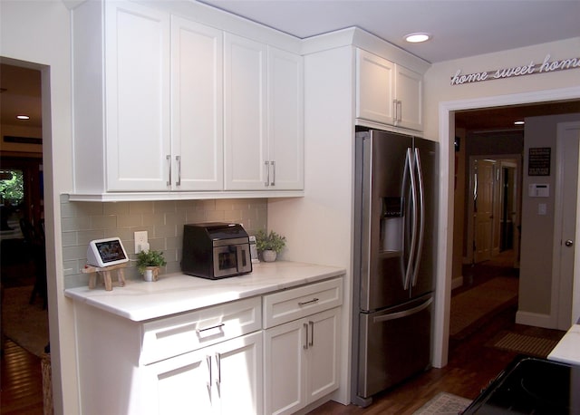 68 Palmer Dr, Sayville, NY 11782 - kitchen featuring stainless steel refrigerator with ice dispenser, white cabinets, decorative backsplash, dark wood-style floors, and recessed lighting