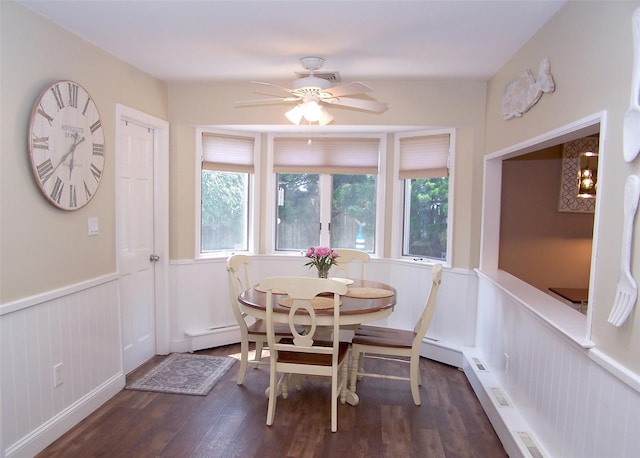 68 Palmer Dr, Sayville, NY 11782 - dining space featuring dark wood-style flooring, wainscoting, ceiling fan, baseboard heating, and a decorative wall